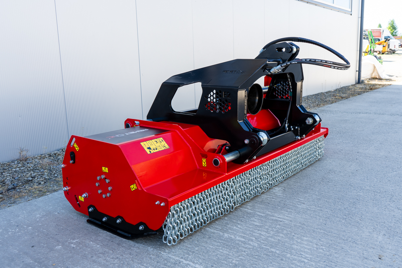 Original product image of a red Remet F2-175 flail mower, showing its heavy-duty steel housing, front chain guards, hydraulic hoses and reinforced mounting frame.