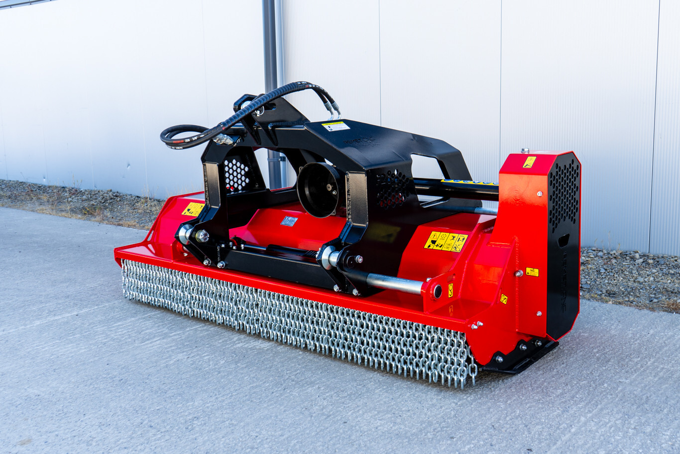 Original product image of a red Remet F2-175 flail mower from Northern Woodsmen, showing the hydraulic side-shift setup, heavy-duty frame and front chain guards.