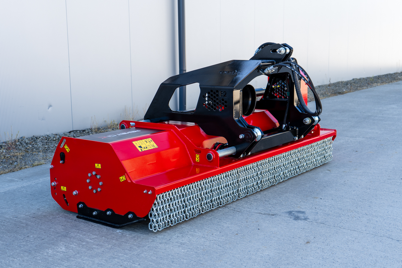 A Remet F2 Series flail mower displayed with its hydraulic side shift system and heavy-duty construction. The image highlights the robust design and wider cutting capacity of the mower, built for demanding applications including dense grass, brush, woody material, and large-scale land management tasks.